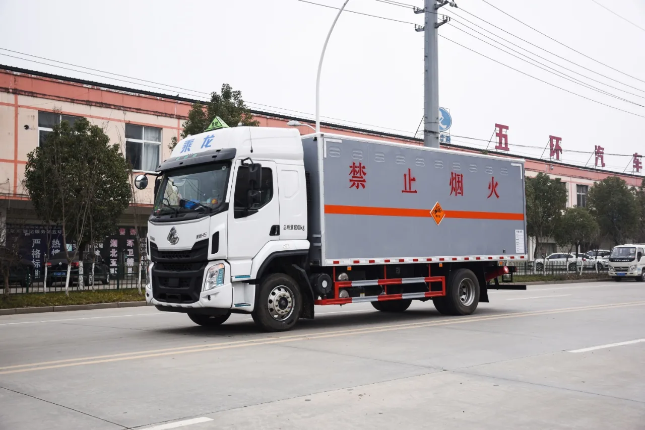 乘龙H5危化品厢式运输车 右前45度行驶实拍：灰色厢体（禁止烟火大字+橙色反光带+红色菱形标志）+ 350L铝合金油箱 + 275/80R22.5轮胎